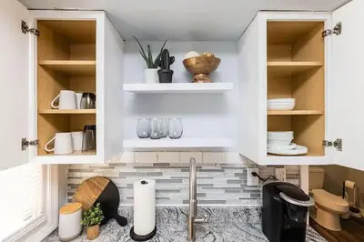 a kitchen with white cabinets and a sink at The Beautiful Jenkins Getaway in Columbus