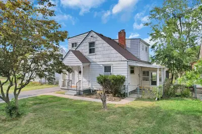 a white house with a porch and a yard at The Columbus Prime - 5 Bedroom 2 Bath- Parking in Columbus