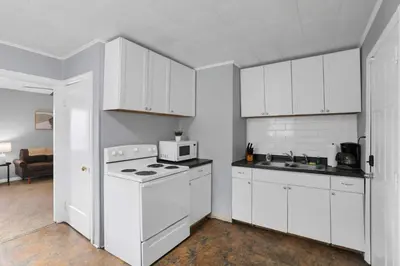 a white kitchen with a stove and a microwave at The Columbus Prime - 5 Bedroom 2 Bath- Parking in Columbus