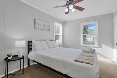 a bedroom with a bed and a ceiling fan at The Columbus Prime - 5 Bedroom 2 Bath- Parking in Columbus