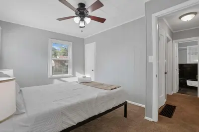 a bedroom with a bed and a ceiling fan at The Columbus Prime - 5 Bedroom 2 Bath- Parking in Columbus