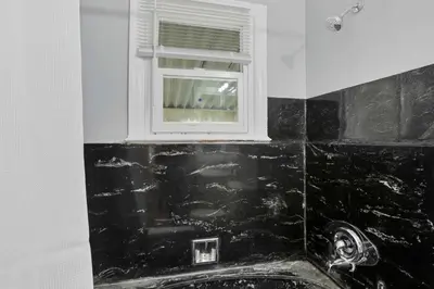 a bathroom with a sink and a window at The Columbus Prime - 5 Bedroom 2 Bath- Parking in Columbus