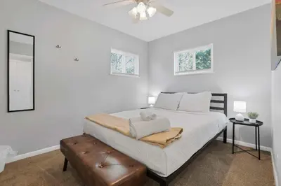 a white bedroom with a bed and a ceiling fan at The Columbus Prime - 5 Bedroom 2 Bath- Parking in Columbus