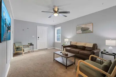 a living room with a couch and a ceiling fan at The Columbus Prime - 5 Bedroom 2 Bath- Parking in Columbus