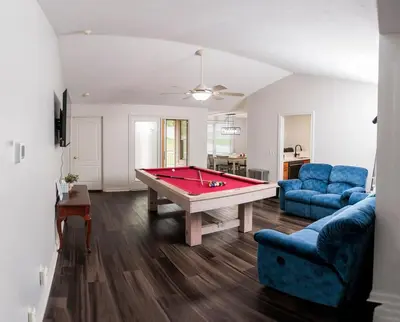 a living room with a red pool table in it at Modern Retreat Near DAY Airport & Metropark in Vandalia