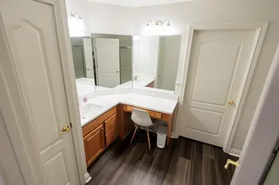 a bathroom with a white sink and a mirror at Modern Retreat Near DAY Airport & Metropark in Vandalia