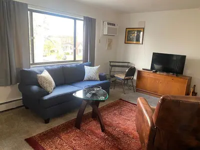 a living room with a blue couch and a table at Lakewood Apartment No 9 in Lakewood