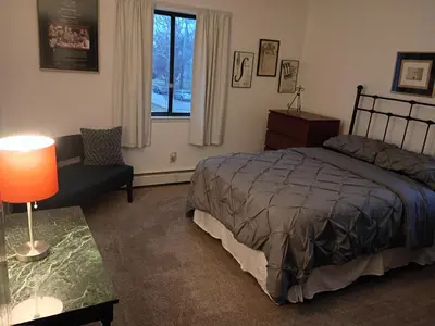 a bedroom with a bed and a chair and a window at Lakewood Apartment No 9 in Lakewood