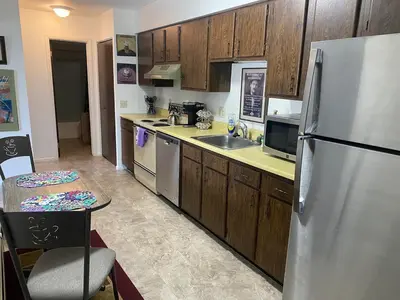 a kitchen with wooden cabinets and a stainless steel refrigerator at Lakewood Apartment No 9 in Lakewood