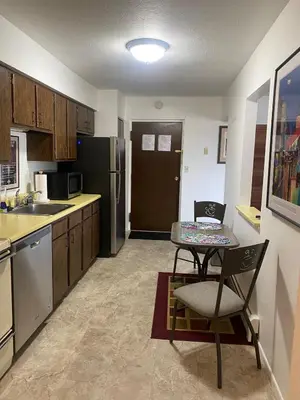 a kitchen with a table and a kitchen with a refrigerator at Lakewood Apartment No 9 in Lakewood