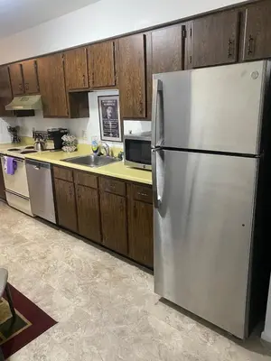 a kitchen with a stainless steel refrigerator and wooden cabinets at Lakewood Apartment No 9 in Lakewood