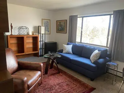 a living room with a blue couch and a chair at Lakewood Apartment No 9 in Lakewood