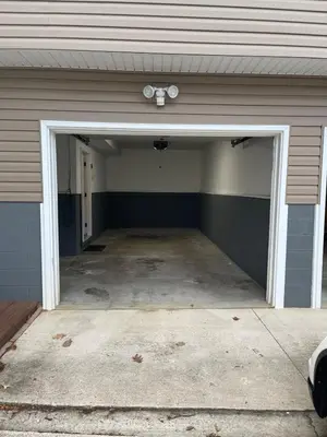 an empty garage with a garage door open at Lovely West Akron home with attached private garage in Akron