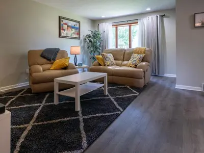 a living room with two couches and a coffee table at Lovely West Akron home with attached private garage in Akron