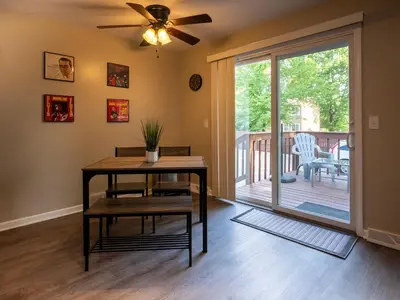 a living room with a table and a sliding glass door at Lovely West Akron home with attached private garage in Akron