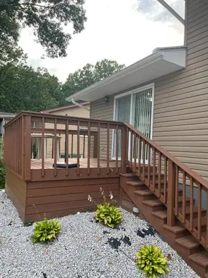 a wooden deck on the side of a house at Lovely West Akron home with attached private garage in Akron