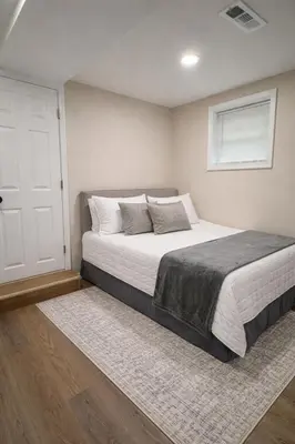 a bedroom with a large bed and a window at Brand new first floor studio in quiet neighborhood in Akron
