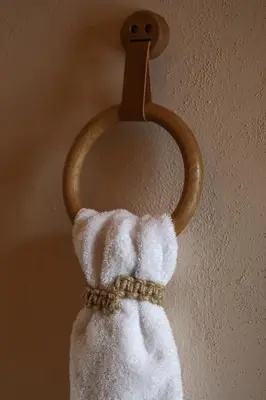 a towel hanging on a wall with a wooden holder at trekløveren in Covington
