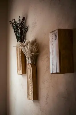 a vase with flowers in it hanging on a wall at trekløveren in Covington