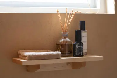 a shelf with two bottles of soap and a towel at trekløveren in Covington