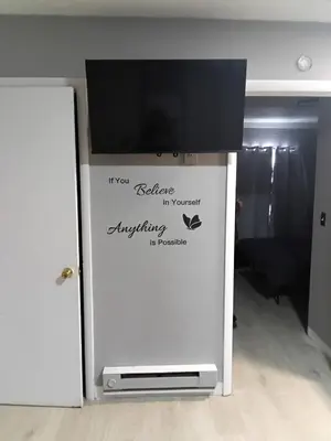a flat screen tv on top of a refrigerator at Cosy single-level home with laundry and parking in Huntington
