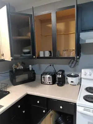 a kitchen counter with a toaster and a toaster oven at Cosy single-level home with laundry and parking in Huntington