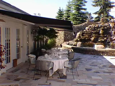 a table and chairs sitting on a patio at Mario's International Spa, Hotel & Restaurant in Aurora