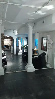 a living room with couches and columns in a building at Mario's International Spa, Hotel & Restaurant in Aurora