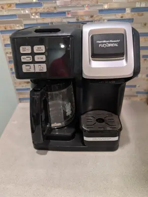 a black coffee maker with a microwave on top of it at The Grand Landmark 5-Story Windmill Retreat in Lorain