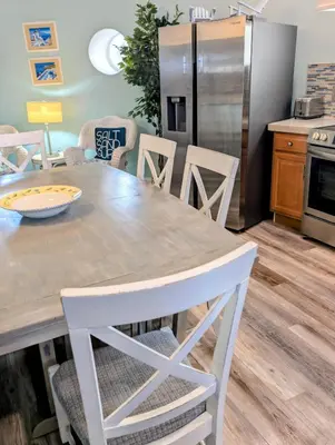 a kitchen with a table and chairs and a refrigerator at The Grand Landmark 5-Story Windmill Retreat in Lorain