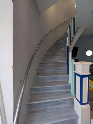 a spiral staircase with blue and white railings at The Grand Landmark 5-Story Windmill Retreat in Lorain