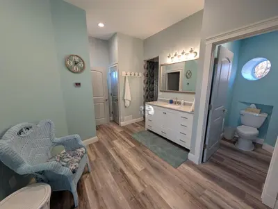 a bathroom with a toilet and a sink at The Grand Landmark 5-Story Windmill Retreat in Lorain