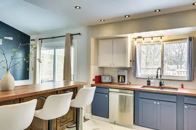 a kitchen with blue cabinets and white appliances at Close to BW Campus and Univ Hospitals Berea Home in Berea