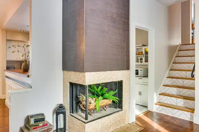 a fireplace in a living room with white walls at Close to BW Campus and Univ Hospitals Berea Home in Berea