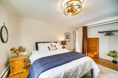 a bedroom with a large bed and a chandelier at Close to BW Campus and Univ Hospitals Berea Home in Berea