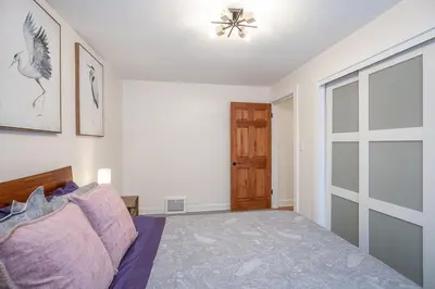 a bedroom with a bed and a sliding glass door at Charming Renovated Home in Lakewood in Lakewood