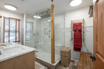 a bathroom with a shower and a sink and a tub at Charming Renovated Home in Lakewood in Lakewood