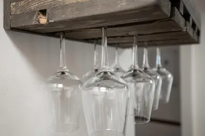 a group of wine glasses hanging from a rack at Charming Renovated Home in Lakewood in Lakewood