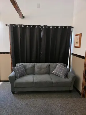 a couch in a room with a black curtain at Our Place in Nelsonville