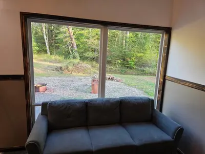 a living room with a couch in front of a window at Our Place in Nelsonville