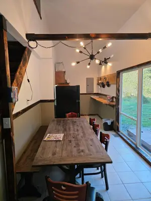 a dining room with a wooden table and chairs at Our Place in Nelsonville