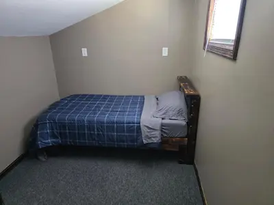 a small bedroom with a bed in the corner at Our Place in Nelsonville