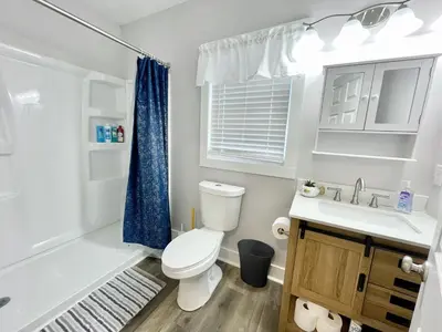 a white bathroom with a toilet and a sink at Newly Remodeled 2 Bedroom Home in Shelbyville Family Friendly in Shelbyville