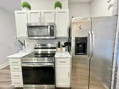 a kitchen with a stainless steel refrigerator and a microwave at Newly Remodeled 2 Bedroom Home in Shelbyville Family Friendly in Shelbyville