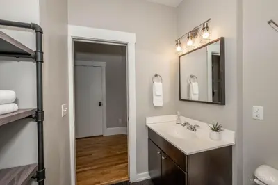 a bathroom with a sink and a mirror at Gimme Shelter - OTR Cininnati in Cincinnati