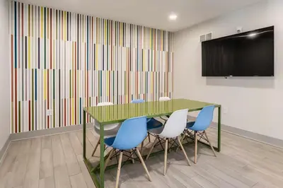 a conference room with a green table and blue chairs at Cincinnati Downtown Oasis in Cincinnati