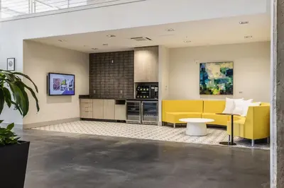a kitchen with a yellow couch and a table at Cincinnati Downtown Oasis in Cincinnati