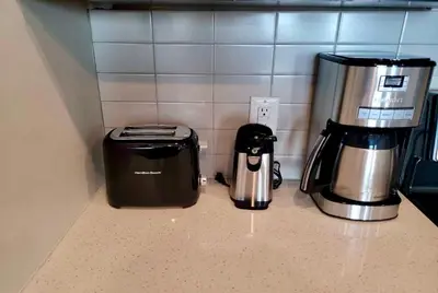 a coffeemaker and a coffee maker on a kitchen counter at Cincinnati Downtown Oasis in Cincinnati