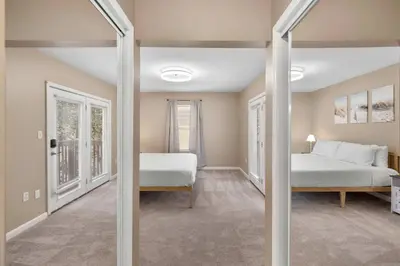 a bedroom with two beds and a mirror at Tusculum Hilltop Haven For 8 in Cincinnati