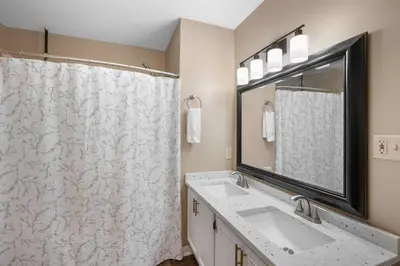 a bathroom with a sink and a shower at Tusculum Hilltop Haven For 8 in Cincinnati